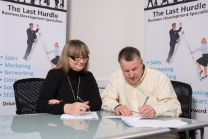 Tony signing his franchise agreement with franchisor Jules White.