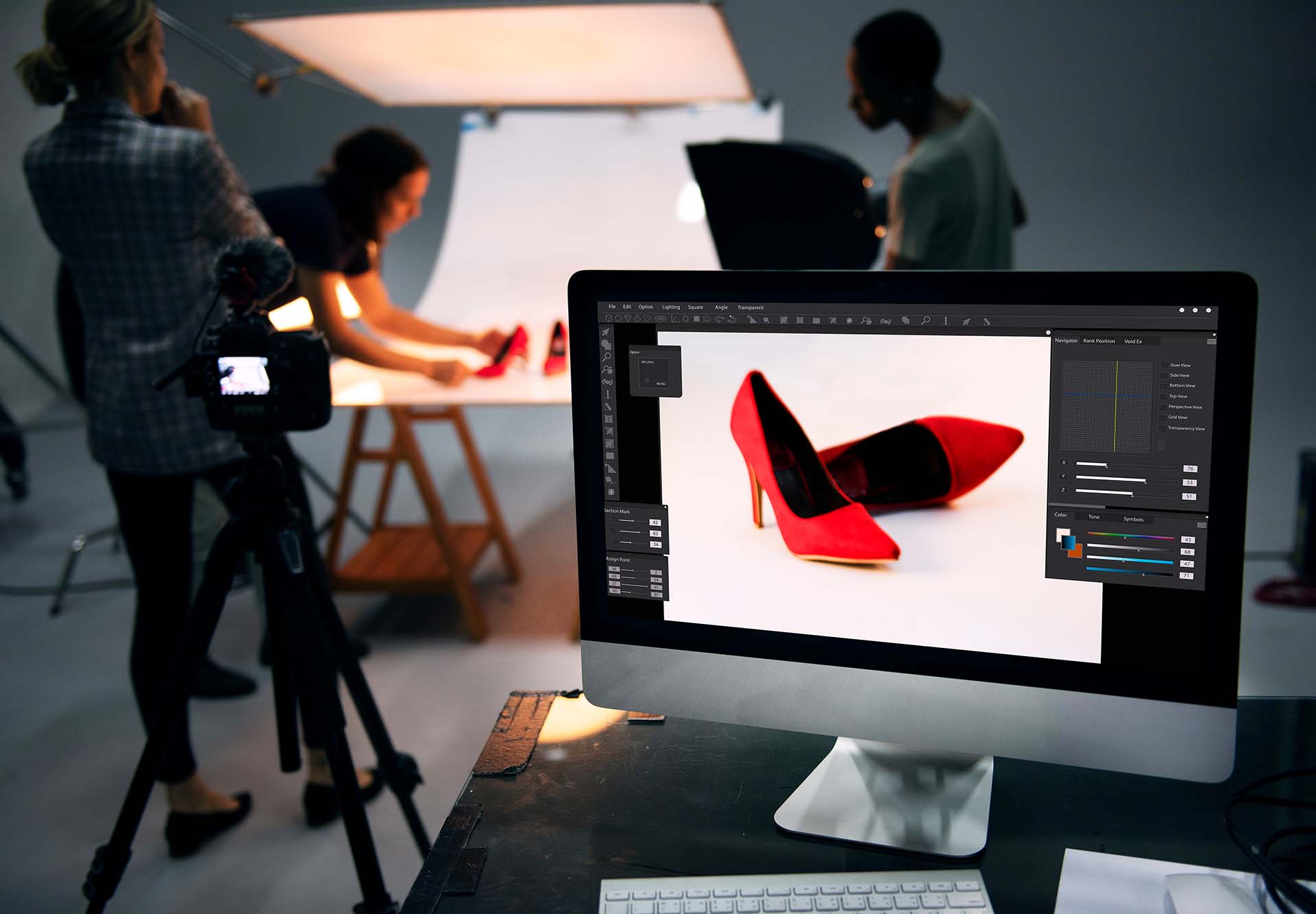 Product Photography Tips: A monitor showing an edited picture of red shoes, whilst in the background the team are prepping the shoes for the next shot