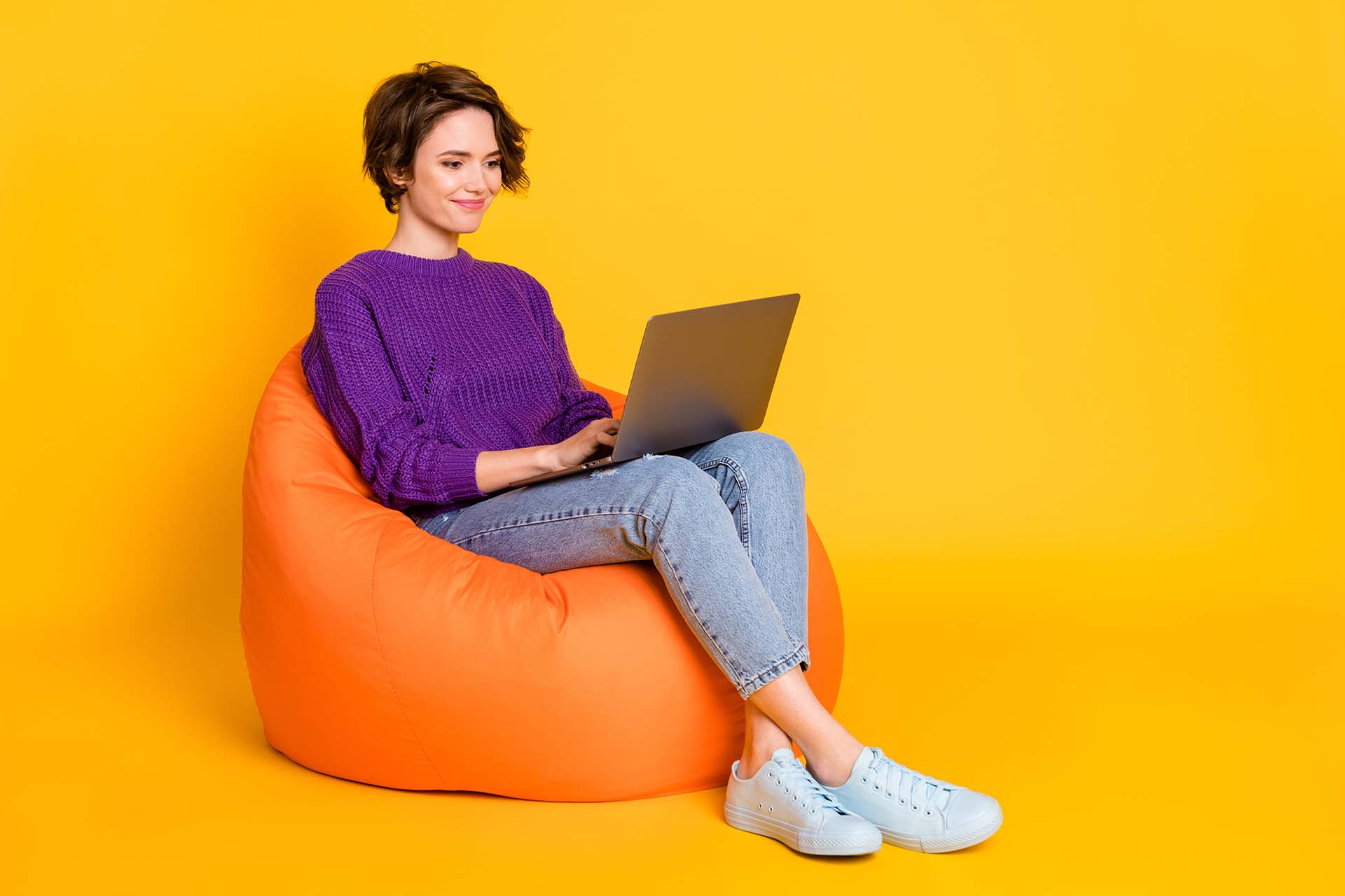 How to Write a Press Release a lady in a purple jumper sitting on an orange bean bag