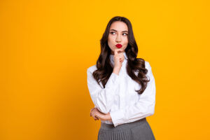 Website Credibility Clues this image shows a bright yellow background with a thoughtfulkly well dressed lady in the foreground