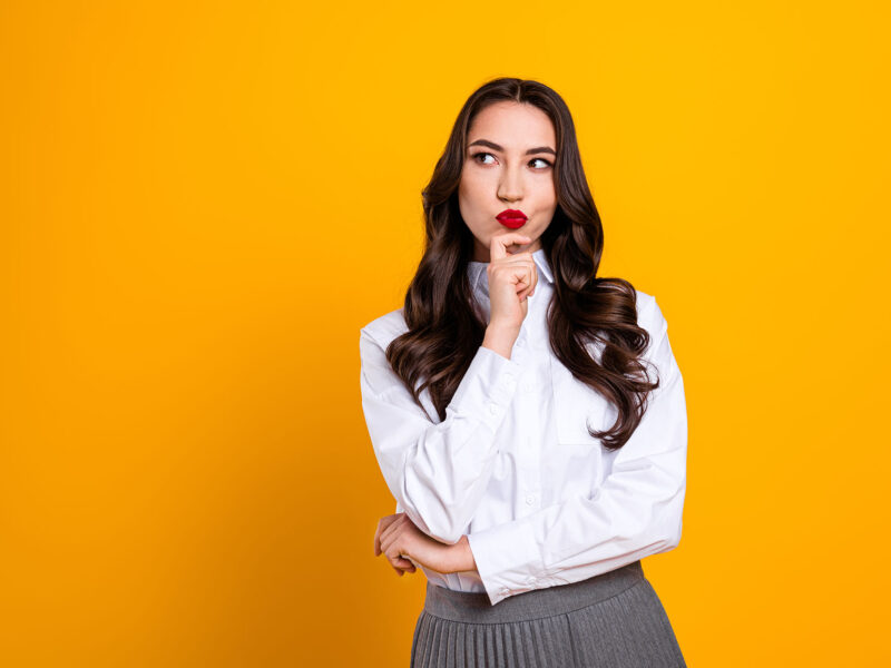 Website Credibility Clues this image shows a bright yellow background with a thoughtfulkly well dressed lady in the foreground